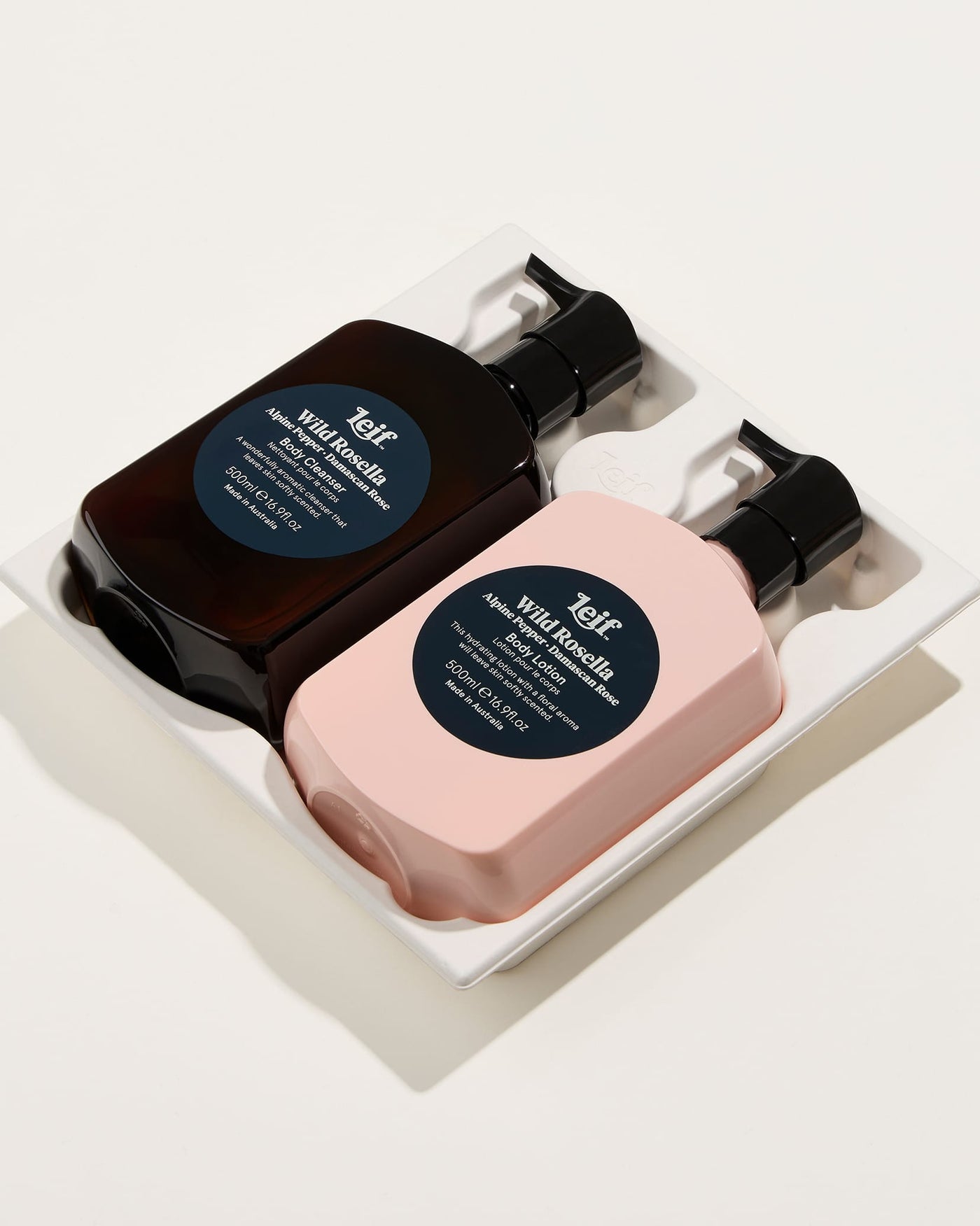 Wild Rosella 500ml Body Lotion and Wild Rosella 500ml Body Cleanser in paper tray.