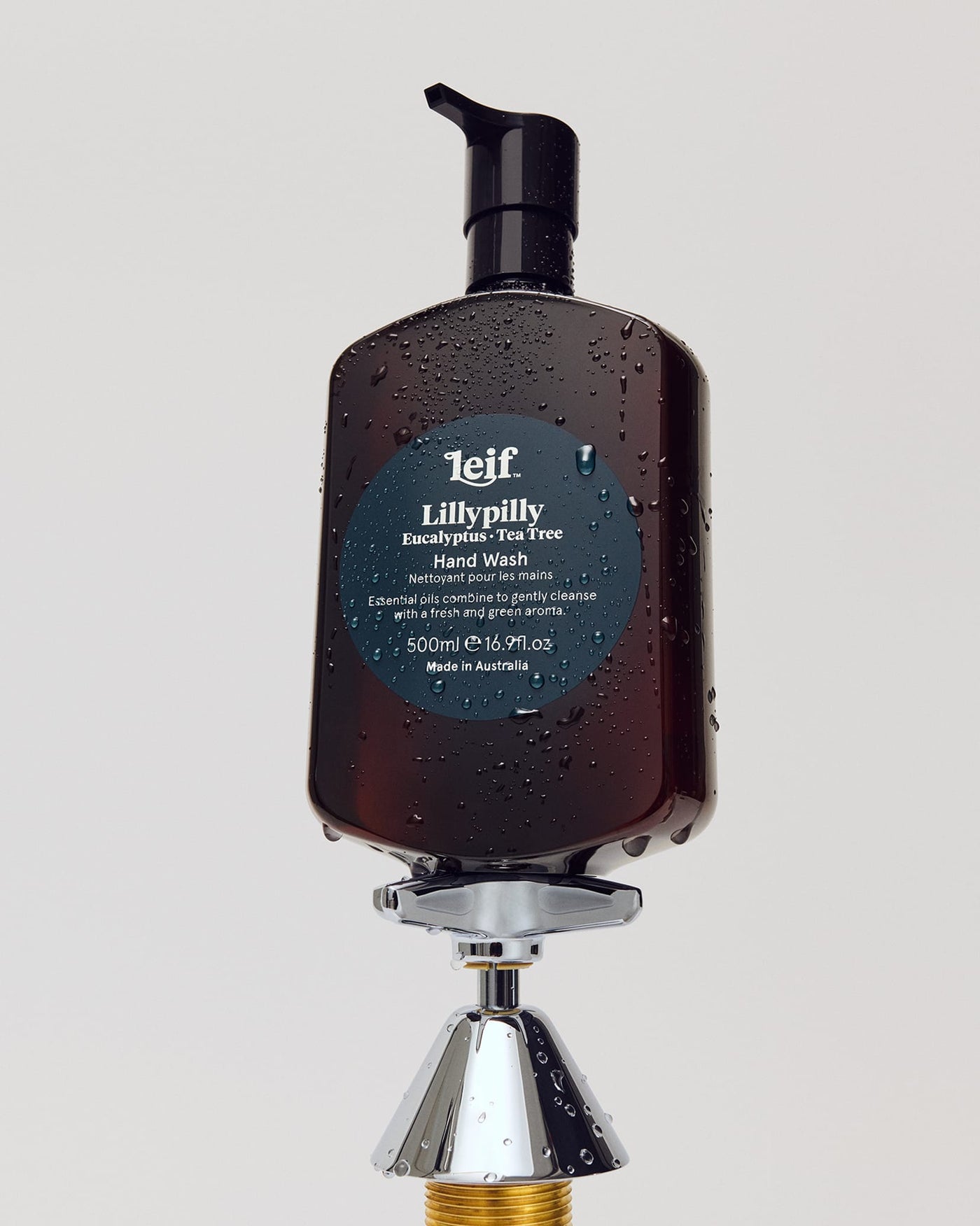 Leif Lillypilly Hand Wash bottle balancing on a tap fixture.